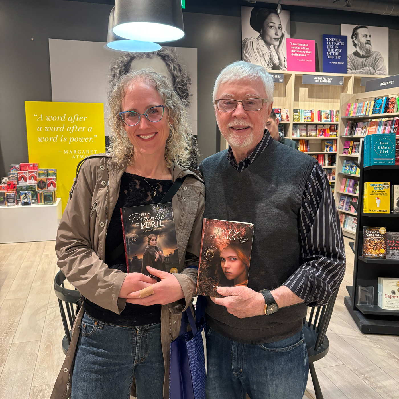 James Allen and a reader holding the finished From Promise to Peril and Tracks of Our Tears books in a bookstore